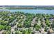 Aerial view showcases a tranquil neighborhood with tree-lined streets, nearby lake, and well-maintained homes at 7872 S Hill Dr, Littleton, CO 80120