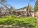 A spacious backyard features a large, well-maintained lawn, a patio with pergola and a shed, perfect for outdoor enjoyment at 7872 S Hill Dr, Littleton, CO 80120