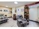 A versatile basement offers a relaxation area, bed and workout space providing flexible options for various activities at 7872 S Hill Dr, Littleton, CO 80120