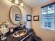 Charming powder room with elegant fixtures, a decorative mirror, and a stylish sink at 7872 S Hill Dr, Littleton, CO 80120