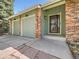 Charming brick home with a two-car garage, decorative front door, and manicured lawn at 7872 S Hill Dr, Littleton, CO 80120