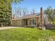 Charming single-story home features brick accents, a lawn, and a two-car garage at 7872 S Hill Dr, Littleton, CO 80120