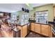 Open kitchen and dining area with sleek countertops, stainless steel appliances, and hardwood floors at 7872 S Hill Dr, Littleton, CO 80120
