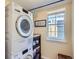 Efficient laundry area featuring stacked washer/dryer unit and convenient storage at 7872 S Hill Dr, Littleton, CO 80120
