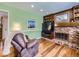 Comfortable living room with brick fireplace, wood floors, and natural light at 7872 S Hill Dr, Littleton, CO 80120