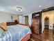 Bright main bedroom with wood floors, a ceiling fan, and spacious dresser at 7872 S Hill Dr, Littleton, CO 80120