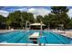 Outdoor pool area featuring clear blue water, diving board, and lounge chairs for relaxing by the poolside at 7872 S Hill Dr, Littleton, CO 80120