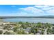 An aerial view shows a lake and the surrounding community with mature trees and landscaping at 4301 S Pierce St # 4D, Littleton, CO 80123