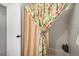 Bathroom featuring a floral curtain, beige shower curtain, and tile walls at 4301 S Pierce St # 4D, Littleton, CO 80123