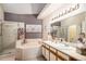 A luxurious bathroom with dual sinks, a soaking tub, separate shower, and decorative accents for a spa-like experience at 4301 S Pierce St # 4D, Littleton, CO 80123