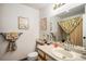 Stylish bathroom featuring floral-themed decor, a vanity with sink, and coordinated accessories at 4301 S Pierce St # 4D, Littleton, CO 80123