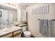 Bright bathroom featuring a vanity with sink, decorative wall art, and a coordinated towel set for a fresh, clean look at 4301 S Pierce St # 4D, Littleton, CO 80123