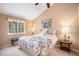 Comfortable bedroom featuring a floral bedding set, a window with natural light, and cozy bedside lamps at 4301 S Pierce St # 4D, Littleton, CO 80123
