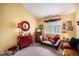 Charming bedroom with a red dresser, decorative accents, a cozy settee and a window with natural light at 4301 S Pierce St # 4D, Littleton, CO 80123