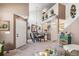 Open-concept dining area with stylish chandelier, staircase view and access to the kitchen at 4301 S Pierce St # 4D, Littleton, CO 80123