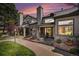 Charming townhouse exterior with manicured landscaping and private entrance under a colorful sunset sky at 4301 S Pierce St # 4D, Littleton, CO 80123