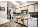 Well-lit kitchen with white cabinets, countertops, and modern appliances for cooking and meal preparation at 4301 S Pierce St # 4D, Littleton, CO 80123