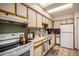 Bright kitchen with white cabinets, updated appliances, and tile flooring for modern living at 4301 S Pierce St # 4D, Littleton, CO 80123