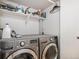 A laundry room features modern LG washer and dryer, storage shelving, and utility supplies at 4301 S Pierce St # 4D, Littleton, CO 80123