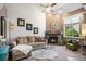 Bright living room features a fireplace, large window, and plush seating, perfect for relaxing or entertaining at 4301 S Pierce St # 4D, Littleton, CO 80123