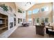 Spacious living room featuring fireplace, high ceilings, many windows, and neutral-toned decor at 4301 S Pierce St # 4D, Littleton, CO 80123