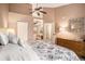 Spacious main bedroom with floral bedding, ensuite bathroom access, and natural light from the window at 4301 S Pierce St # 4D, Littleton, CO 80123