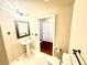 Bathroom features pedestal sink, toilet, tiled floors, and doorway at 1441 Central St # 203, Denver, CO 80211