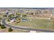 Wide aerial view of the house, garage, and spacious backyard, fenced and bordered by trees at 29145 E 160Th Ct, Brighton, CO 80603
