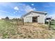 Barn exterior with sliding door, wood fence, and a camper parked adjacent in a scenic setting at 29145 E 160Th Ct, Brighton, CO 80603