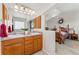 Spacious bathroom featuring wood cabinets and dual sinks with natural light pouring in at 29145 E 160Th Ct, Brighton, CO 80603