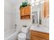 Bright bathroom featuring tiled shower, cabinet, and vanity with a light color palette at 29145 E 160Th Ct, Brighton, CO 80603