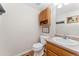 This half bathroom features wood cabinetry and a neutral color palette at 29145 E 160Th Ct, Brighton, CO 80603