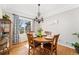 Bright dining room with a wood table, chandelier, and window with floral curtains at 29145 E 160Th Ct, Brighton, CO 80603