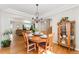 Open-concept dining room with wood flooring, round table, and adjacent living area at 29145 E 160Th Ct, Brighton, CO 80603