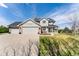 Charming two-story home boasts an attached three-car garage and well-manicured lawn at 29145 E 160Th Ct, Brighton, CO 80603
