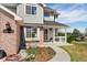 Inviting front porch with well-manicured landscaping and brick accents on a beautiful home at 29145 E 160Th Ct, Brighton, CO 80603