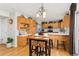 Well-lit kitchen featuring wooden cabinets, a breakfast bar, stainless steel appliances, and stylish pendant lighting at 29145 E 160Th Ct, Brighton, CO 80603