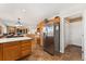 Open kitchen area provides access to the living room and stainless steel refrigerator, as well as other modern appliances at 29145 E 160Th Ct, Brighton, CO 80603