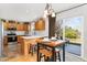 Well-lit kitchen features stainless appliances, bright white countertops and backsplash, and sliding door to outdoor patio area at 29145 E 160Th Ct, Brighton, CO 80603