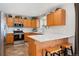 Well-appointed kitchen with stainless steel appliances, white subway tile backsplash, and breakfast bar with seating area at 29145 E 160Th Ct, Brighton, CO 80603