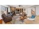 Comfortable living room with stone fireplace, built-in bookshelves, and ample seating at 29145 E 160Th Ct, Brighton, CO 80603