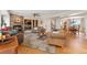 Open-concept living room featuring a fireplace, built-in shelving, comfortable seating, and hardwood flooring at 29145 E 160Th Ct, Brighton, CO 80603