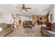 Bright living room with hardwood floors, ceiling fan, and seamlessly flowing into the adjacent kitchen and dining areas at 29145 E 160Th Ct, Brighton, CO 80603