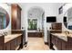 Elegant bathroom with dual vanities, tiled floors, and a view of the soaking tub and shower at 7208 Raphael Ln, Littleton, CO 80125