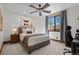 Bedroom with neutral tones, plush bedding, natural light, and unique modern wall art at 7208 Raphael Ln, Littleton, CO 80125