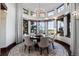 Elegant dining room with large windows providing an abundance of natural light and scenic outdoor views at 7208 Raphael Ln, Littleton, CO 80125