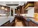 Chef's kitchen with professional-grade appliances, farmhouse sink, custom cabinetry and stone countertops at 7208 Raphael Ln, Littleton, CO 80125