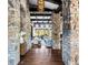 Elegant entryway flowing into a living room with stone columns, hardwood floors, and bright, natural light at 7208 Raphael Ln, Littleton, CO 80125
