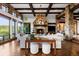 Bright living room featuring stone accents, a fireplace, and large windows with views of the surrounding landscape at 7208 Raphael Ln, Littleton, CO 80125