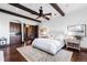 Beautifully decorated bedroom with wood beams, hardwood floors, and a luxurious bed at 7208 Raphael Ln, Littleton, CO 80125